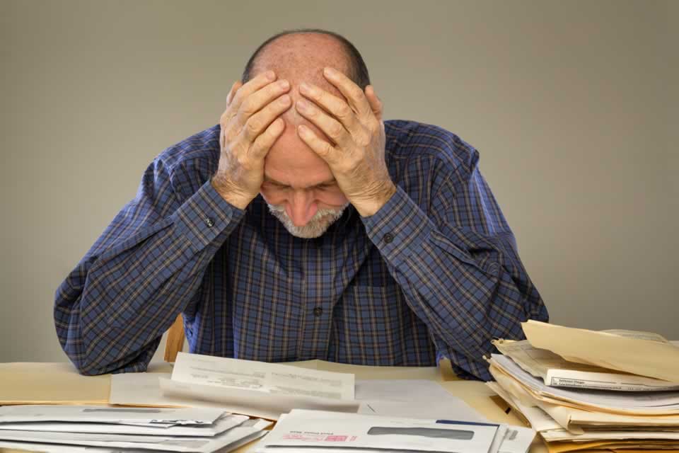 man-overwhelmed-with-paperwork