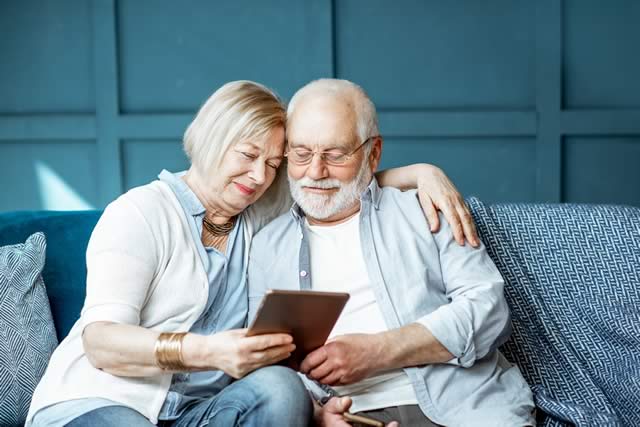 older-couple-together-looking-at-tablet older-couple-together-looking-at-tablet