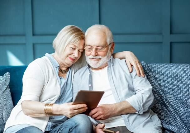 older-couple-together-looking-at-tablet-1